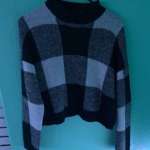 It is a black white and gray sweater